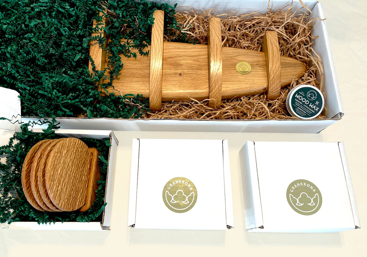 furniture products by grankrona packaged in white boxes with green and natural sizzle paper