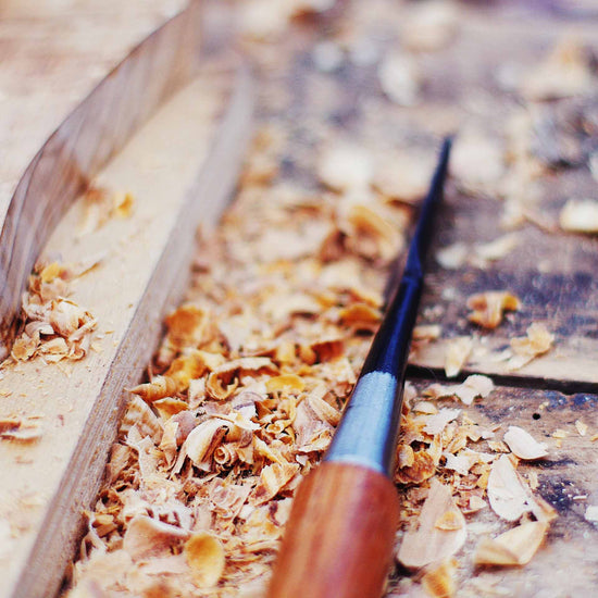 chisel and saw dust on a work bench