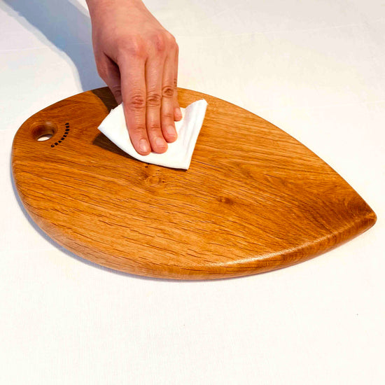 Hand buffing the wood wax finish by grankrona on a cutting board by the same brand