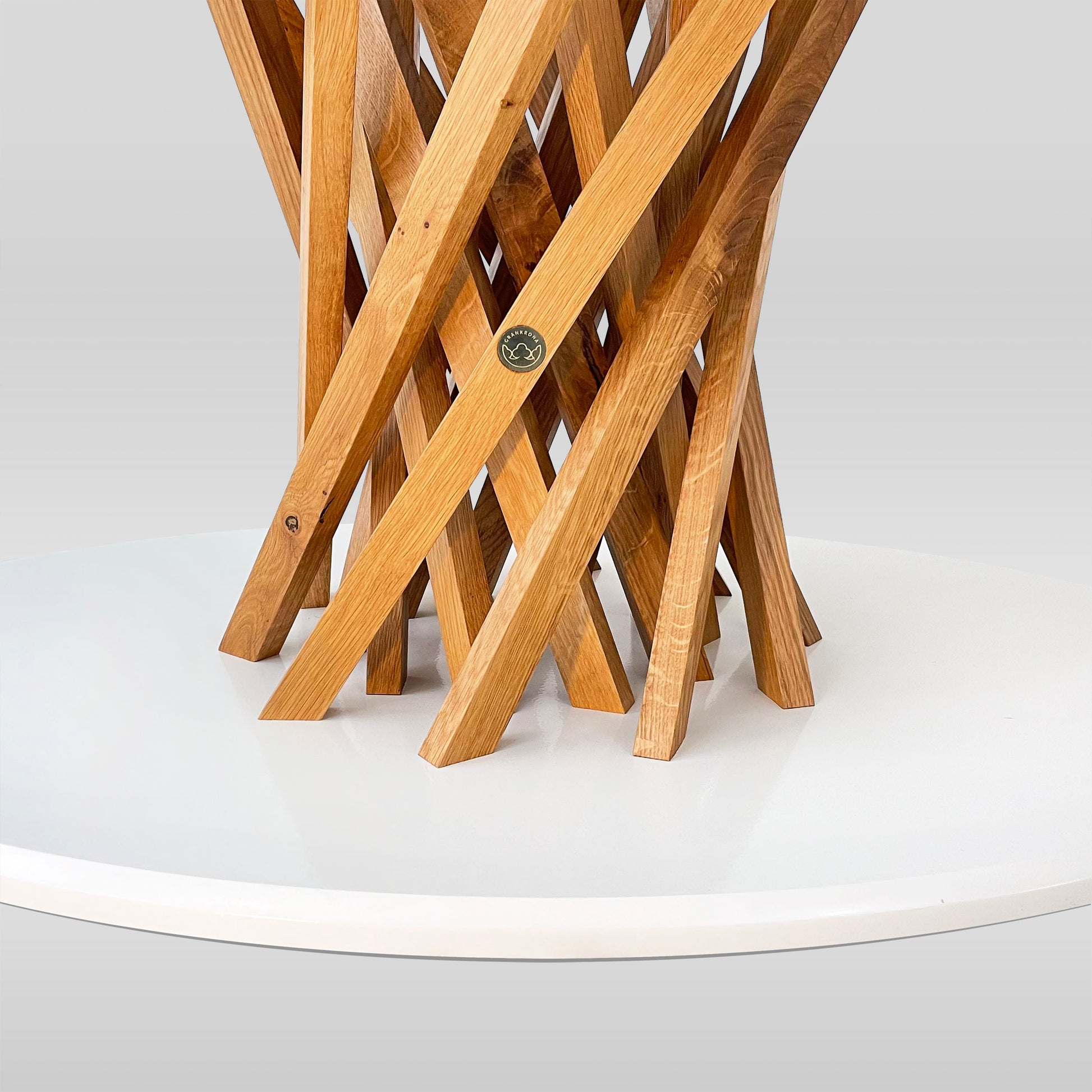 Ygdra dining table showing the logo of Grankrona and the pedestal