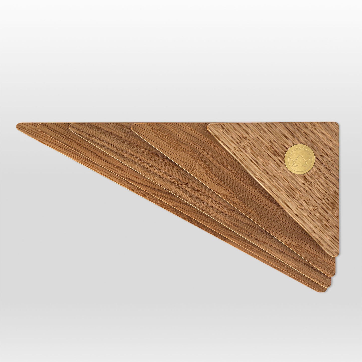 'Cliff' shelf made in oak wood shown from side with brass logo