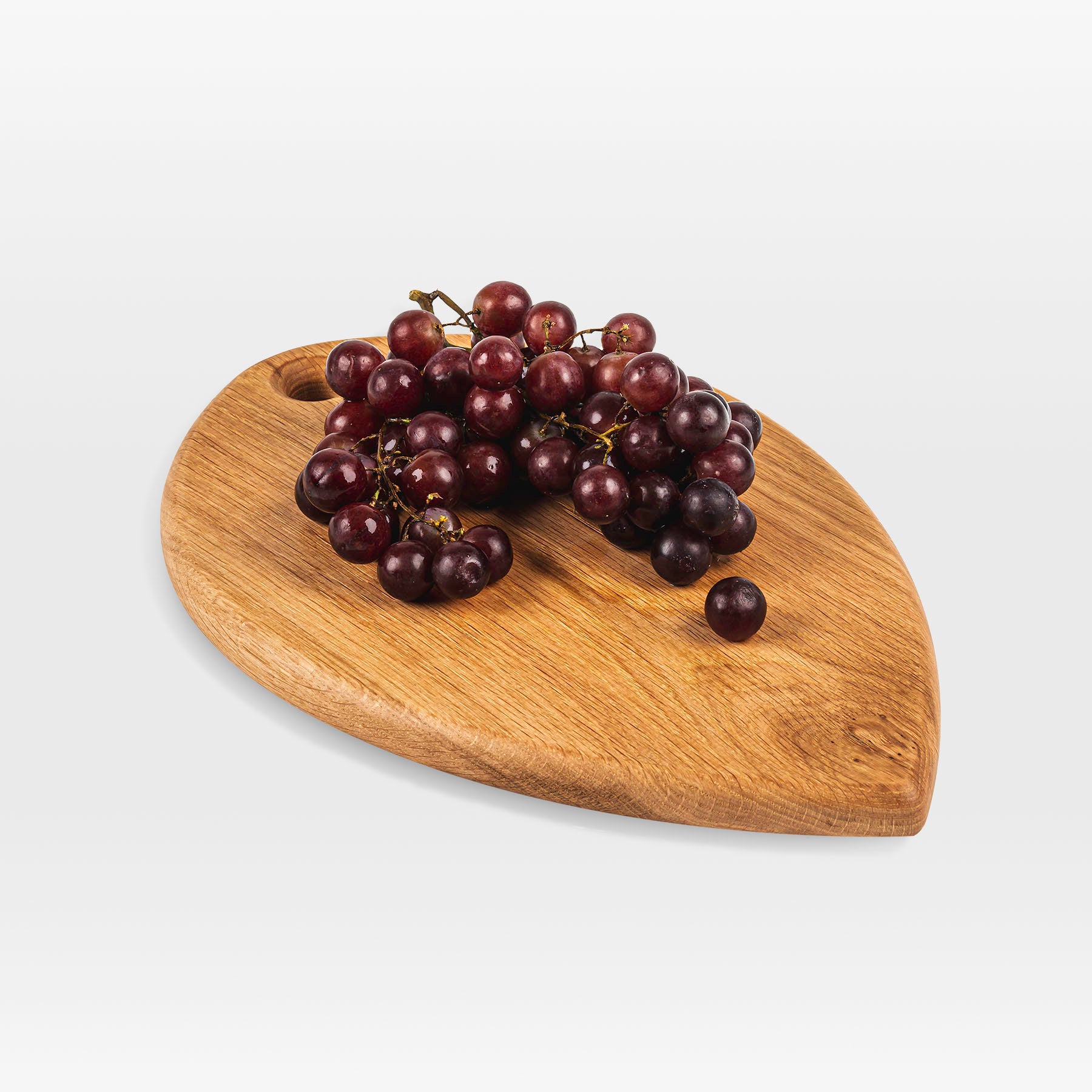 'Petal' serving board by grankrona with red grapes on top
